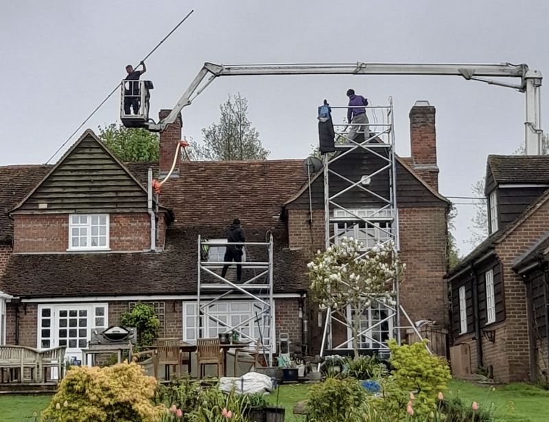 The Moss Cleaners using cherry picker and scaffolding to clean roof safely and professionally in Nuneaton, Warwickshire